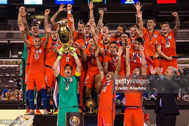 Players of Chile celebrate with the trophy after the championship match between Argentina and Chile at MetLife Stadium as part of Copa America...