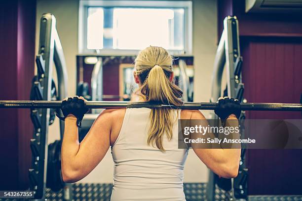 woman exercising in the gym - weight training stock pictures, royalty-free photos & images