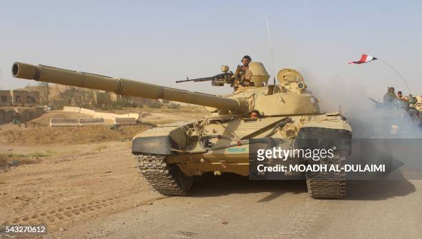 Iraqi government forces are seen with tanks near the Falahat village west of Fallujah on June 27, 2016. Iraqi forces took the Islamic State group's...