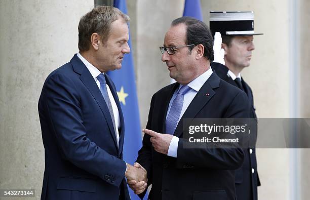 French President Francois Hollande welcomes President of the European Council Donald Tusk prior to attend a meeting at the Elysee Presidential Palace...