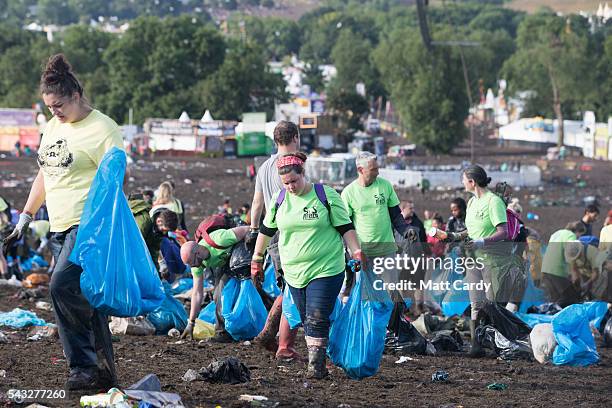 Litter pickers begin the job of clearing the fields in front of the main Pyramid Stage at the Glastonbury Festival 2016 at Worthy Farm, Pilton on...