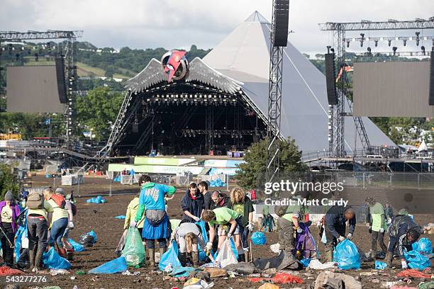 Litter pickers begin the job of clearing the fields in front of the main Pyramid Stage at the Glastonbury Festival 2016 at Worthy Farm, Pilton on...