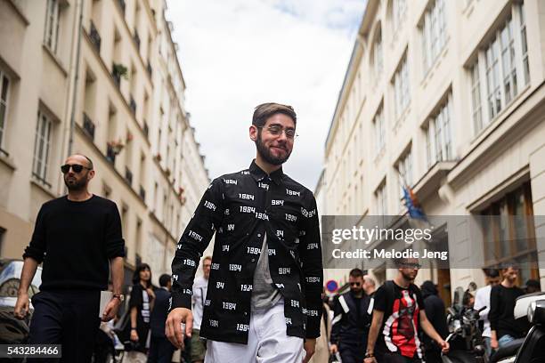 Jacob Gallagher of the Wall Street Journal wears Gosha Rubchinskiy a black Gosha Rubchinskiy "1984" jacket t the Y-3 show on June 25, 2016 in Paris,...