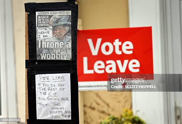 Vote Leave sign is pictured alongside a hand-written note that reads " Vote Leave - If You Do Not The Rest Of The EU Are Coming Here" outside a house...