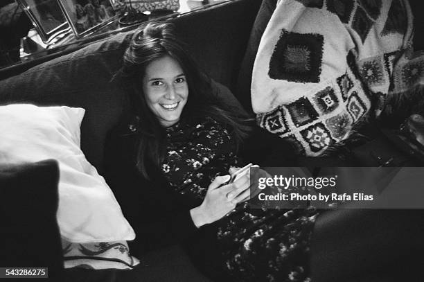 pretty woman sitting on sofa - hands on stomach stock pictures, royalty-free photos & images