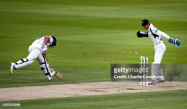 Alviro Petersen of Lancashire goes close to being run out as Middlesex wicket keeper John Simpson looks on duriung day two of the Specsavers County...