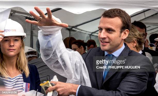 French Economy and Industry minister Emmanuel Macron puts on an overalls as he visits Aperam's stainless facilities in Isbergues, northern France, on...