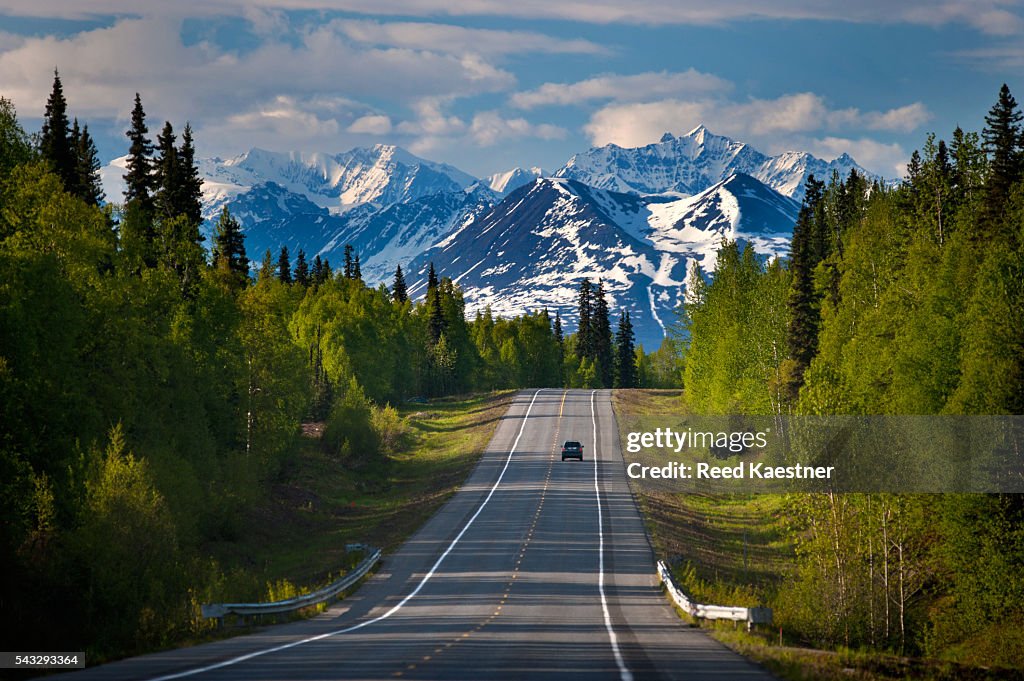 A lone traveler on a remote road in Alaska