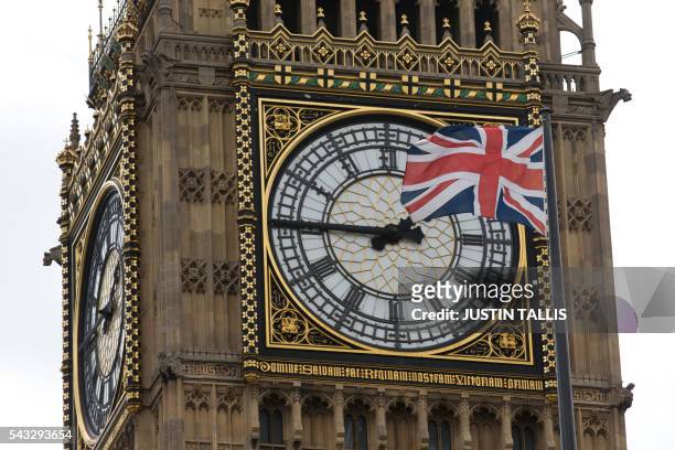 Union flag is seen flapping in the wind in front of one of the faces of the Great Clock atop the landmark Elizabeth Tower that houses Big Ben at the...