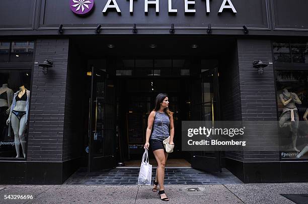 Shopper exits an Athleta Inc. Store in the Center City neighborhood of Philadelphia Pennsylvania, U.S., on Friday, June 24, 2016. The Conference...