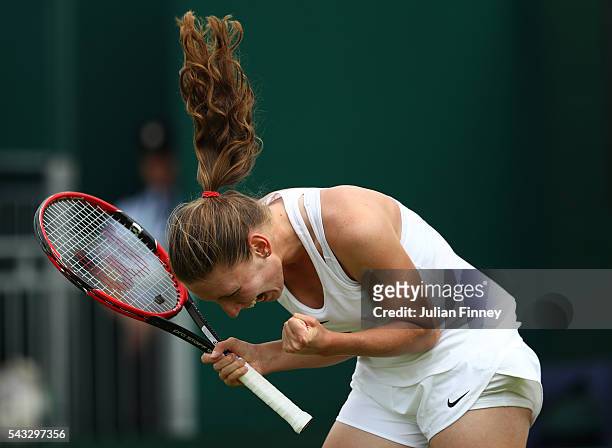 Ekaterina Alexandrova celebrates victory following the Ladies Singles first round match against Ana Ivanovic on day one of the Wimbledon Lawn Tennis...