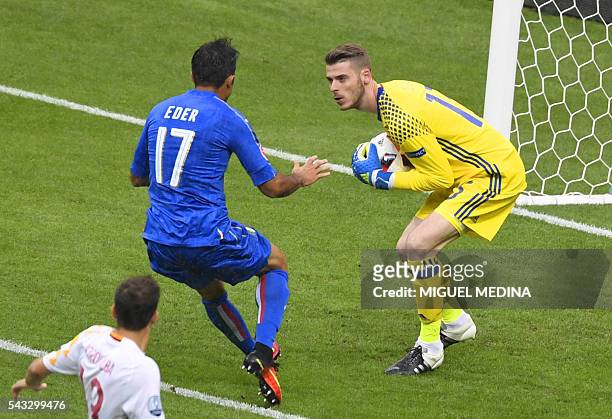 Spain's goalkeeper David De Gea secures a ball in front of Italy's forward Citadin Martins Eder during Euro 2016 round of 16 football match between...