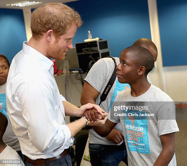 Prince Harry greets his old friend 16 year-old Relebohile 'Mutsu' Potsane who is singing as part of the Basotho Youth Choir, made up of six boys and...