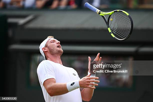 Sam Groth of Australia reacts during the Men's Singles first round against Kei Nishikori of Japan on day one of the Wimbledon Lawn Tennis...