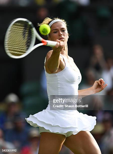 Camila Giorgi of Italy stretches for the ball during the Ladies Singles first round match against Gabrine Muguruza of Spain of Italy on day one of...