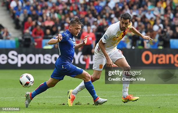 Sergio Busquets of Spain and Emanuele Giaccherini of Italy compete for the ball during the UEFA EURO 2016 round of 16 match between Italy and Spain...