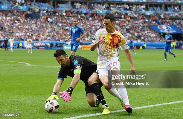 Aritz Aduriz of Spain and Gianluigi Buffon of Italy compete for the ball during the UEFA EURO 2016 round of 16 match between Italy and Spain at Stade...
