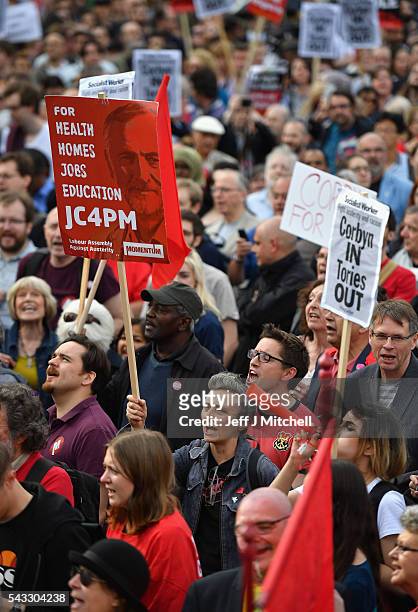 Supporters of Labour leader Jeremy Corbyn hold up signs and shout during Momentum's 'Keep Corbyn' rally outside the Houses of Parliament on June 27,...