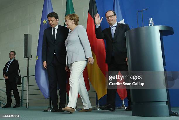 German Chancellor Angela Merkel, French President Francois Hollande and Italian Prime Minister Matteo Renzi depart after speaking to the media during...