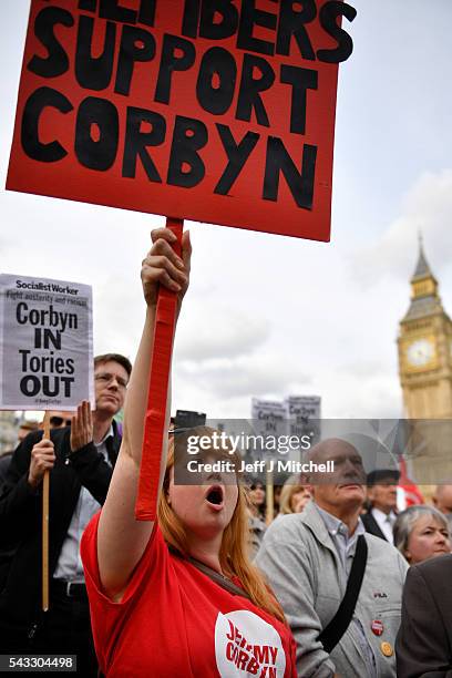 Supporters of Labour leader Jeremy Corbyn hold up signs and shout during Momentum's 'Keep Corbyn' rally outside the Houses of Parliament on June 27,...