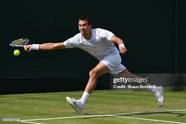 Evgeny Donskoy of Russia plays a forehand shot during the Men's Singles first round against Alexandr Dolgopolov of Ukraine on day one of the...