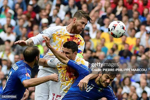 Spain's defender Sergio Ramos heads the ball next to Italy's defender Giorgio Chiellini, Spain's forward Aritz Aduriz and Italy's midfielder Marco...