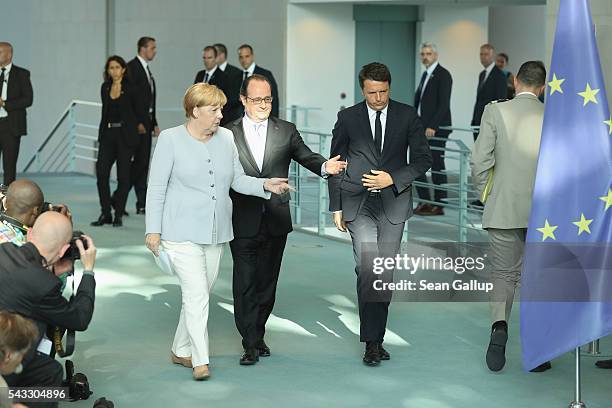 German Chancellor Angela Merkel, French President Francois Hollande and Italian Prime Minister Matteo Renzi arrive to speak to the media during talks...