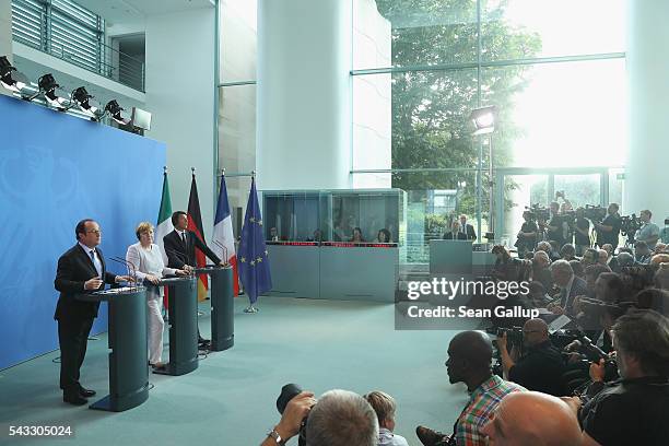 German Chancellor Angela Merkel, French President Francois Hollande and Italian Prime Minister Matteo Renzi speak to the media during talks at the...