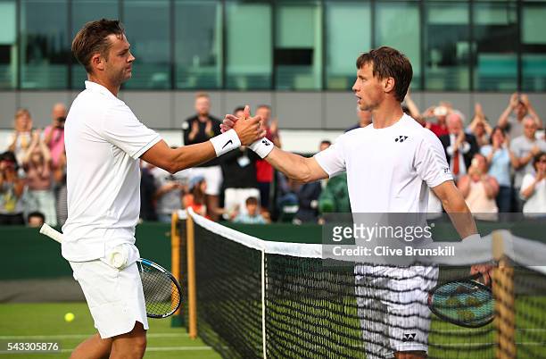 Marcus Willis of Great Britain shakes hands with Ricardas Berankis of Lithuania during the Men's Singles first round match on day one of the...