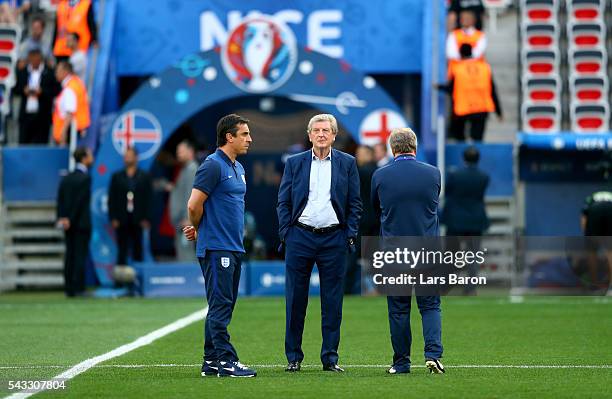 England manager Roy Hodgson speaks with his assistant coaches Ray Lewington and Gary Neville prior to kickoff during the UEFA EURO 2016 round of 16...