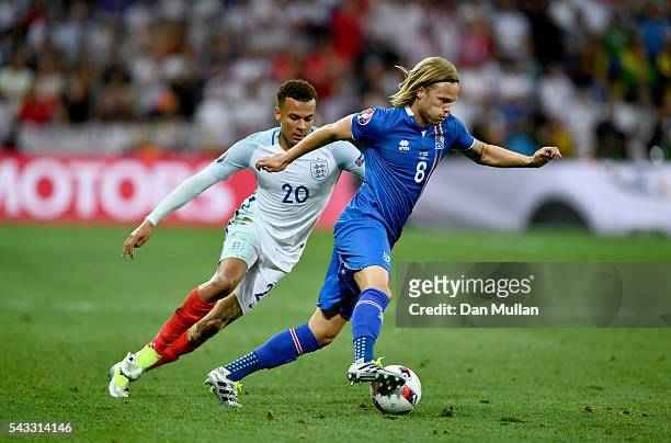Birkir Bjarnason of Iceland and Dele Alli of England compete for the ball during the UEFA EURO 2016 round of 16 match between England and Iceland at...