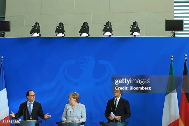 Francois Hollande, France's president, left, speaks as Angela Merkel, Germany's chancellor, center, and Matteo Renzi, Italy's prime minister, listen...