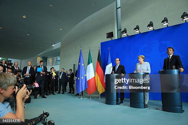 Angela Merkel, Germany's chancellor, center, speaks as Francois Hollande, France's president, left, and Matteo Renzi, Italy's prime minister, listen...