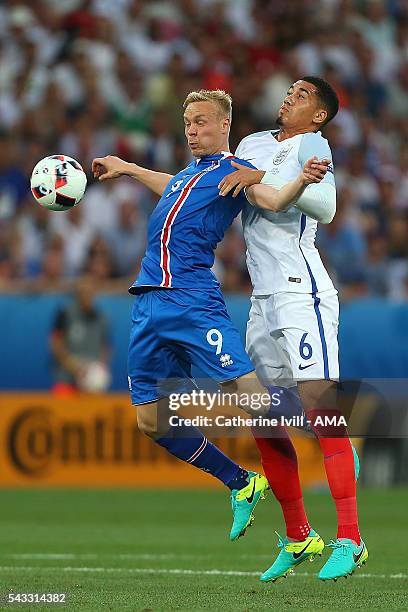 Kolbeinn Sigthorsson of Icelend competes with Chris Smalling of England during the UEFA Euro 2016 Round of 16 match between England and Iceland at...