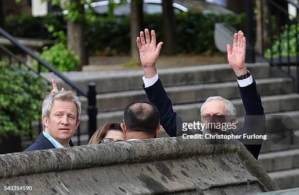 Labour leader Jeremy Corbyn waves to his supportes from the Houses of Parliament during Momentum's 'Keep Corbyn' rally on June 27, 2016 in London,...