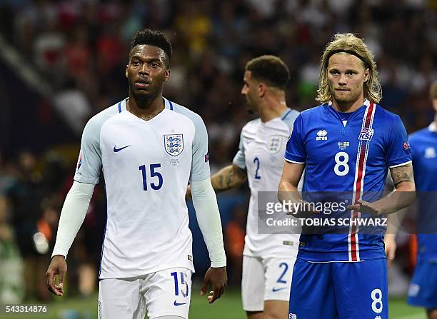 England's forward Daniel Sturridge and Iceland's midfielder Birkir Bjarnason react during Euro 2016 round of 16 football match between England and...