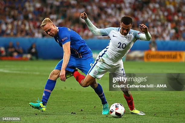 Kolbeinn Sigthorsson of Icelend competes with Dele Alli of England during the UEFA Euro 2016 Round of 16 match between England and Iceland at Allianz...