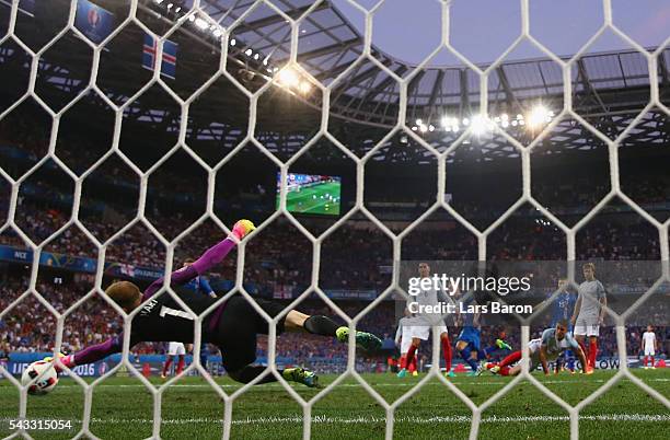 Joe Hart of England dives in vain as Kolbeinn Sigthorsson of Iceland scores his team's second goal during the UEFA EURO 2016 round of 16 match...