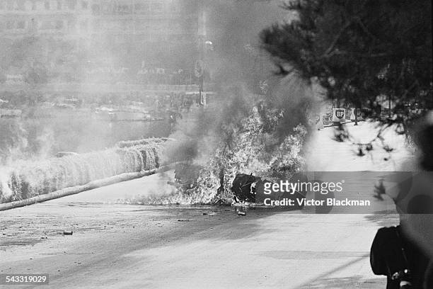 Italian motor racing driver Lorenzo Bandini's Ferrari in flames after crashing during the Monaco Grand Prix, 7th May 1967.