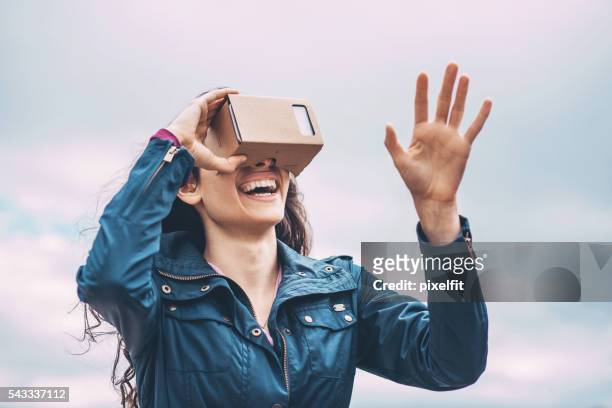 girl with a virtual reality simulator - cardboard vr stock pictures, royalty-free photos & images
