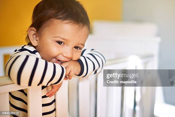 waking up with a smile - baby crib stockfoto's en -beelden