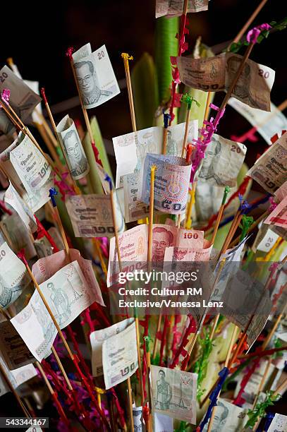 money offerings on new years day at a buddhist temple, bangkok, thailand - buddhist new year photos et images de collection