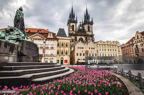 czech republic, prague, monument with flowerbed on old town square - bohemia czech republic stock-fotos und bilder