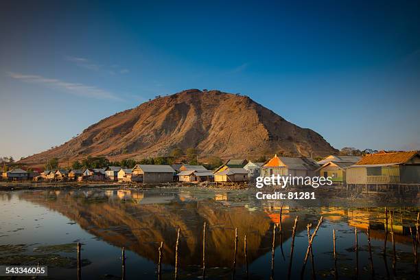 indonesia, sumbawa island, pototano, fisherman village at foot of mountain - fishing village stock pictures, royalty-free photos & images