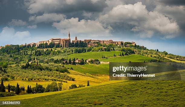 italy, pienza, landscape with old town on top of hill and sky with clouds - pienza stockfoto's en -beelden