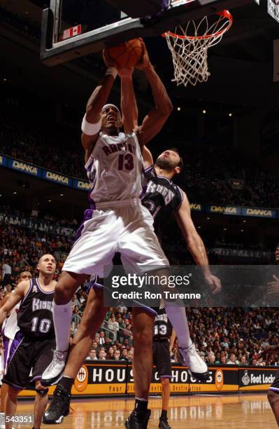 Jerome Williams of the Toronto Raptors goes to the basket against Vlade Divac of the Sacramento Kings during their game at Air Canada Centre in...
