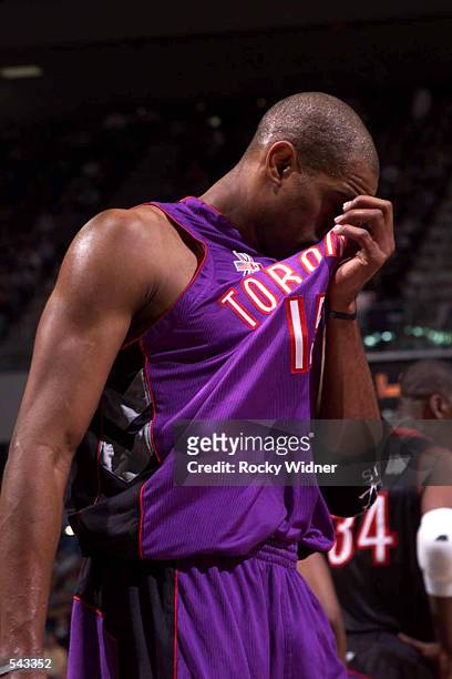 Vince Carter of the Toronto Raptors wipes the sweat from his face during a break against the Sacramento Kings at ARCO Arena in Sacramento,...
