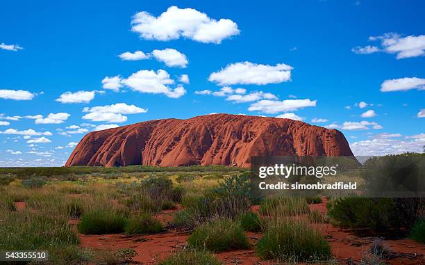 the clouds over uluru - uluru rock stock pictures, royalty-free photos & images