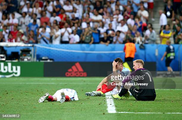 L-r Dele Alli, Gary Cahill and Joe Hart of England shows their dejection after the 1-2 defeat in the UEFA EURO 2016 round of 16 match between England...