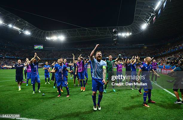 Aron Gunnarsson and Iceland players celebrate their team's 2-1 win with supporters after the UEFA EURO 2016 round of 16 match between England and...